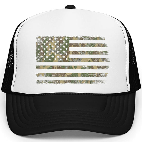 Close-up view of distressed camo American flag graphic on white trucker hat front panel