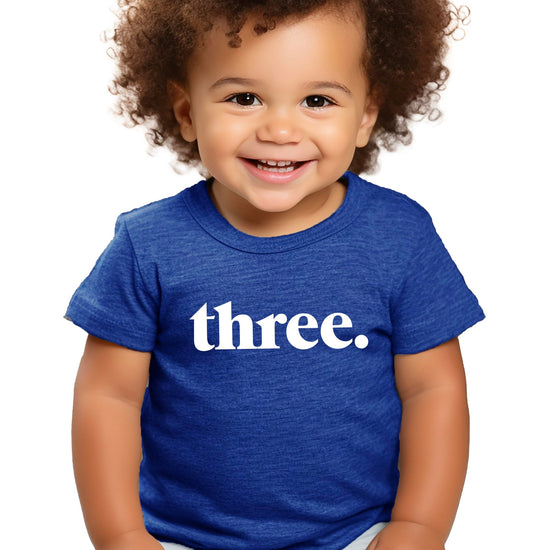 Three period 3rd birthday shirt on toddler with party hat