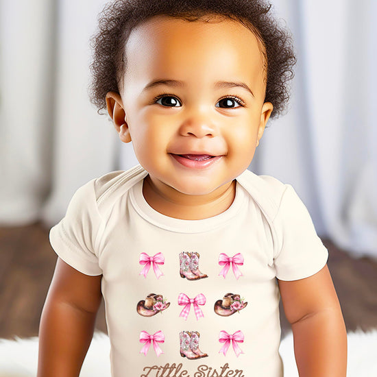 Little Sister baby bodysuit with western cowgirl theme featuring cute bow and boot graphics
