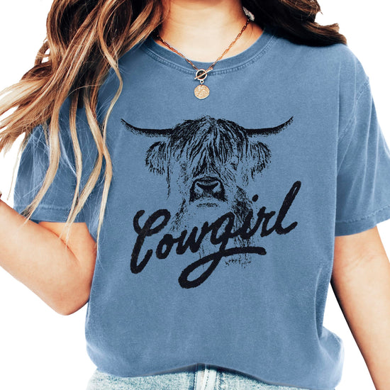 Highland cow cowgirl shirt in blue with rustic western design and trendy script text