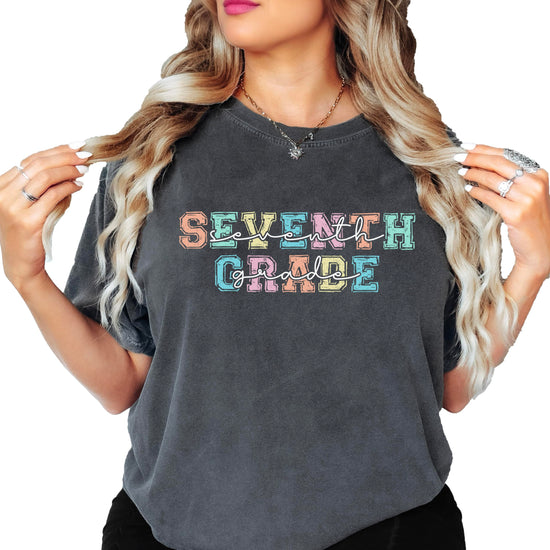 Close-up view of seventh grade graphic tee showing vibrant pastel font design