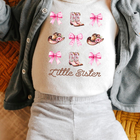 Side view of pink Little Sister baby bodysuit showing comfortable fit and snap closure