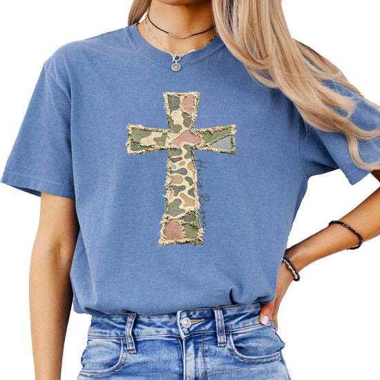 Flat lay of blue Christian Easter shirt with cross graphic design