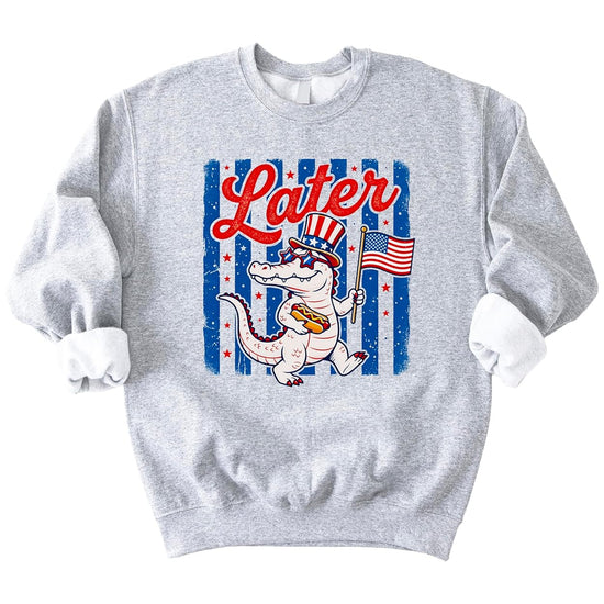 Later Gator patriotic sweatshirt with alligator wearing American flag top hat and sunglasses holding hot dog