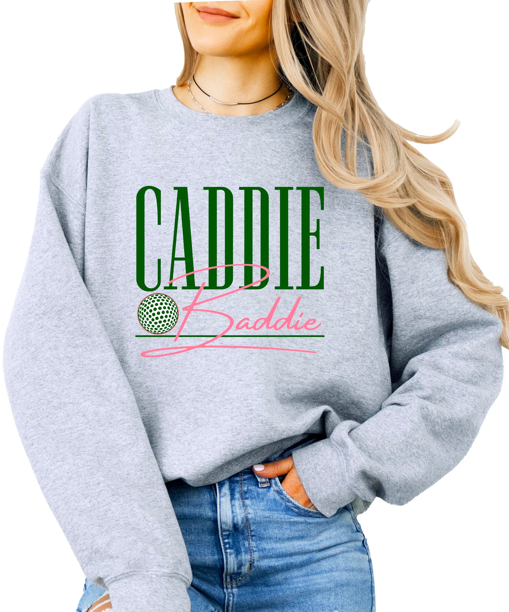 Close-up of Caddie Baddie text design on green women's golf sweatshirt