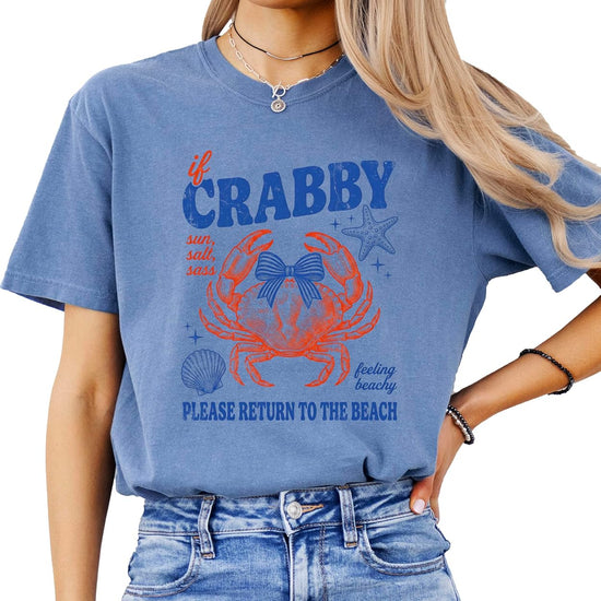 Close-up of vintage crab design with bow, starfish and seashell details on shirt
