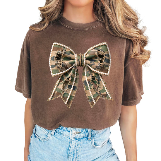 Close-up view of camo and pearls bow graphic design on women's shirt