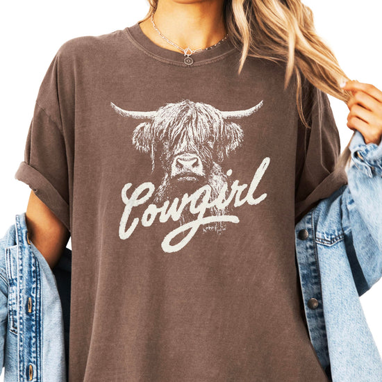 Product flat lay of blue highland cow western graphic tee for women