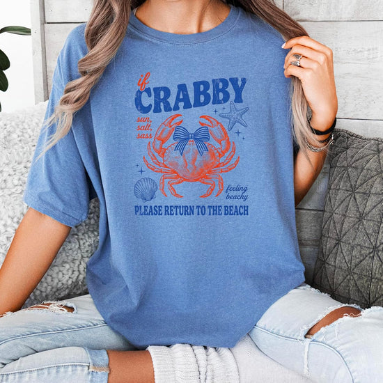 Lifestyle shot of woman in crab graphic tee styled for beach vacation outfit
