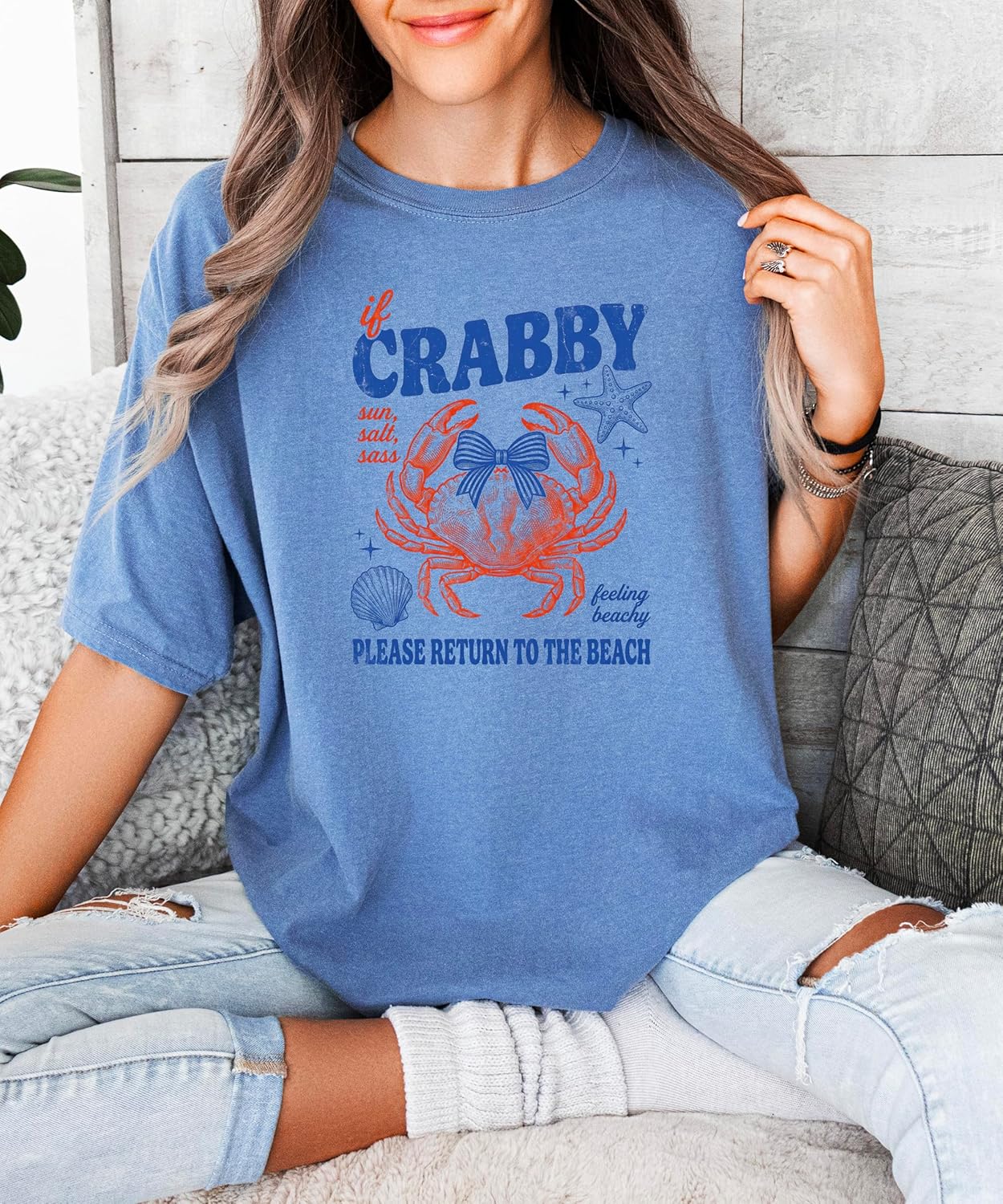 Lifestyle shot of woman in crab graphic tee styled for beach vacation outfit