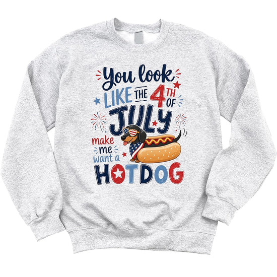 Close-up of funny dachshund in heart sunglasses hotdog bun graphic with patriotic text and fireworks