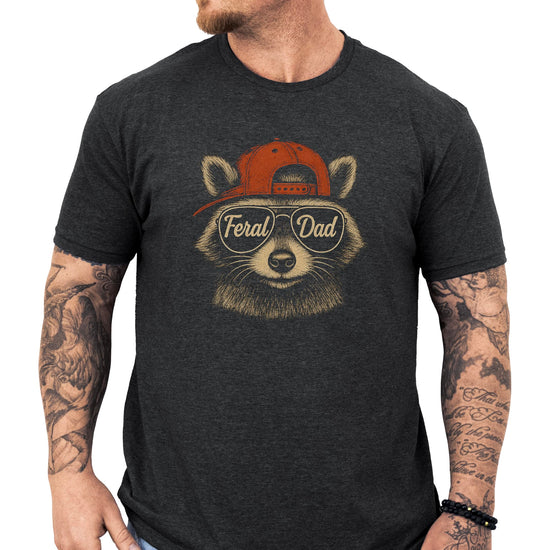 Close-up of Feral Dad raccoon design on black men's t-shirt showing detailed artwork