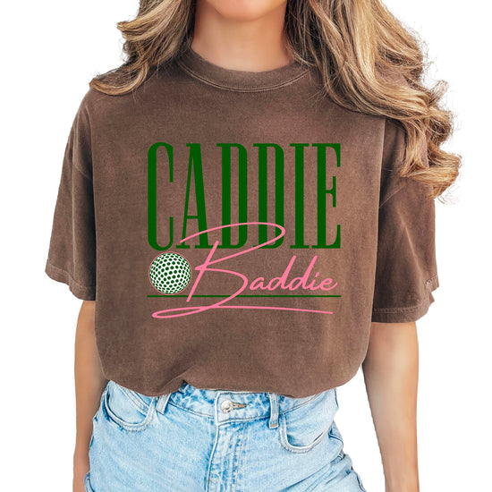 Close-up of Caddie Baddie text graphic design on women's golf tee