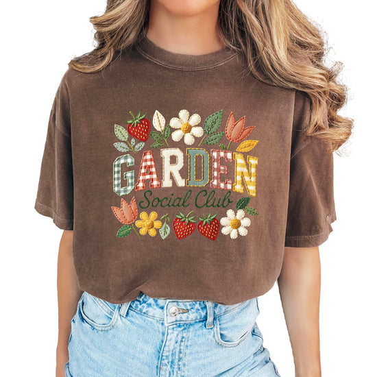 Close-up of Garden Social Club floral graphic print on blue denim shirt showing detailed artwork