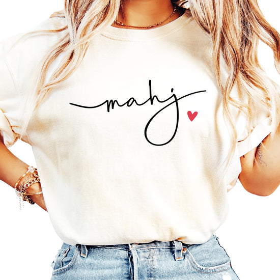 Close-up of hand-lettered mahj script design with red heart accent detail