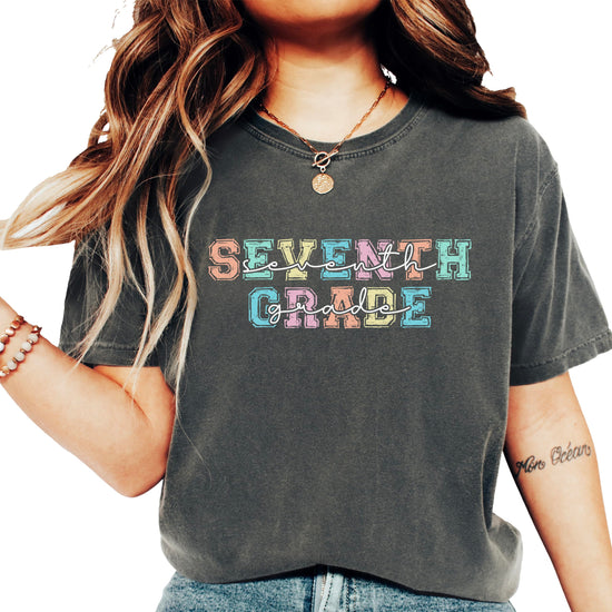 Seventh grade teacher shirt with bold colorful pastel block letters on casual tee