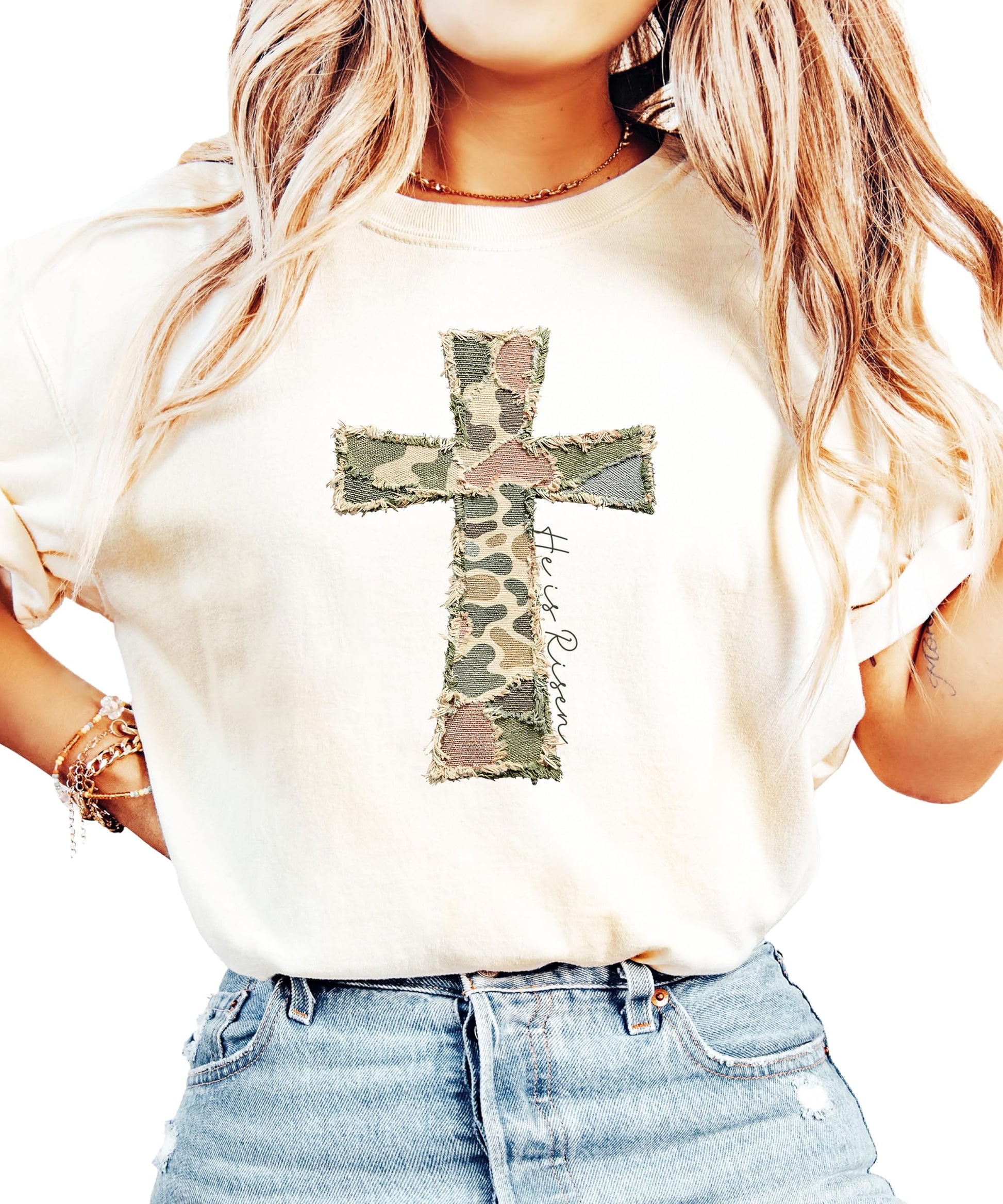 Close-up of He Is Risen cross graphic with colorful patchwork pattern on blue shirt