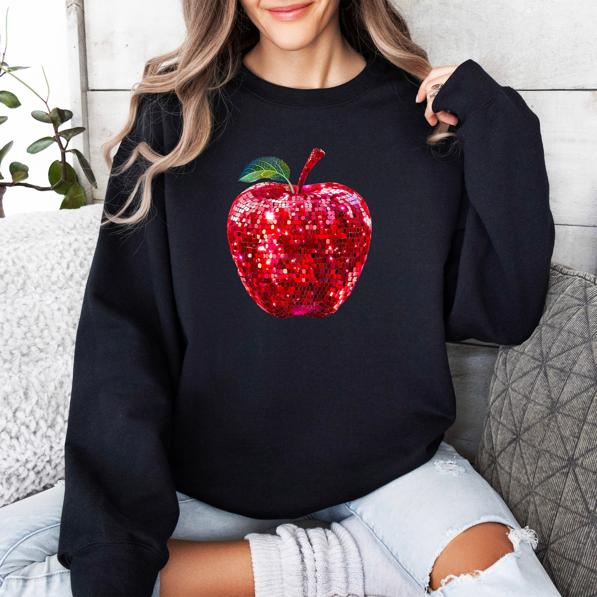 Red disco apple teacher sweatshirt, black sweatshirt, lifestyle view