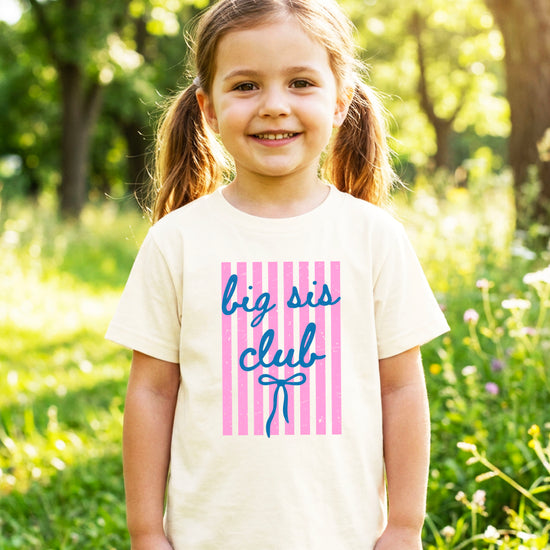Big Sis Club sibling reveal announcement tee in Natural for girls - styled view