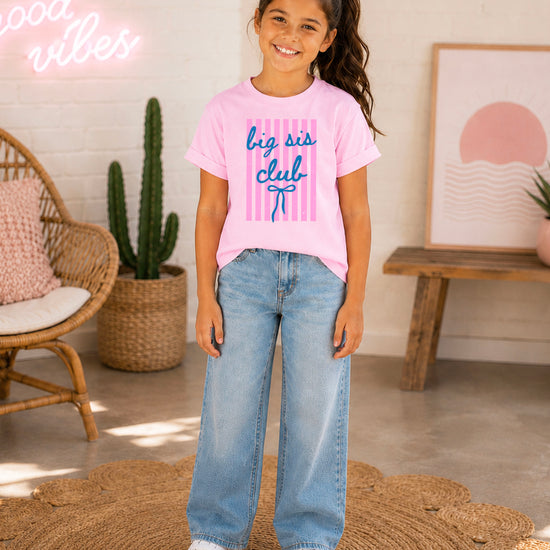 Big Sis Club sibling reveal announcement tee in Pink for girls - styled view