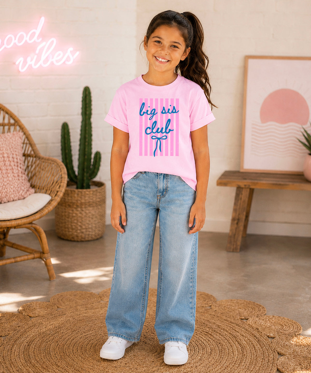 Big Sis Club sibling reveal announcement tee in Pink for girls - styled view