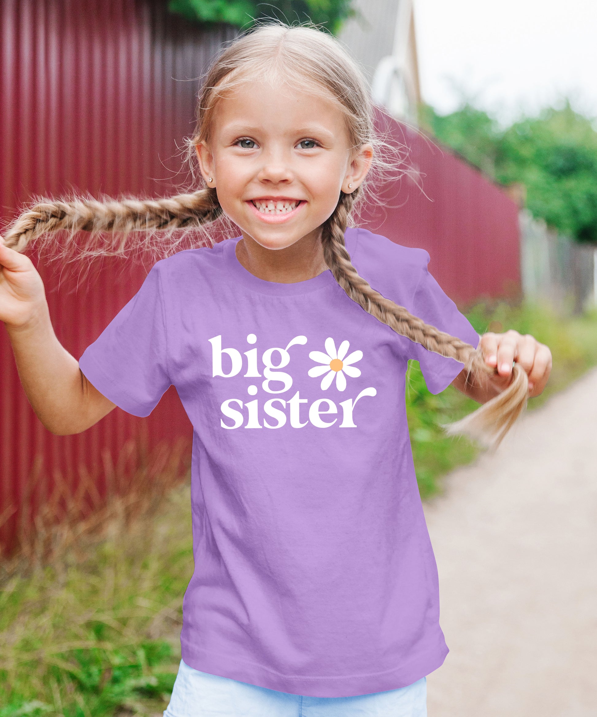 Big Sister Daisy sibling reveal tee for girls in Purple, lifestyle view