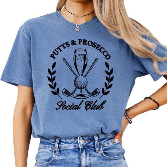 Putts and Prosecco Social Club golf t-shirt for women in Blue Jean, front view