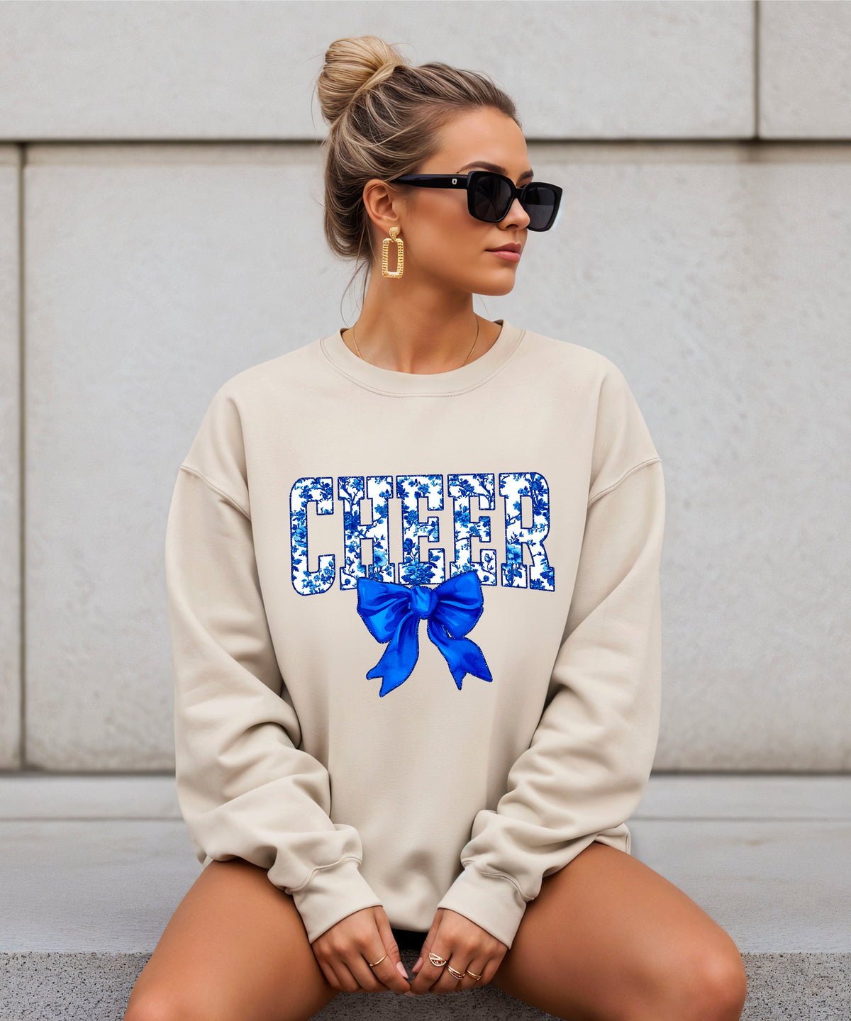 Sand cheer crewneck sweatshirt with blue floral CHEER lettering and coquette bow