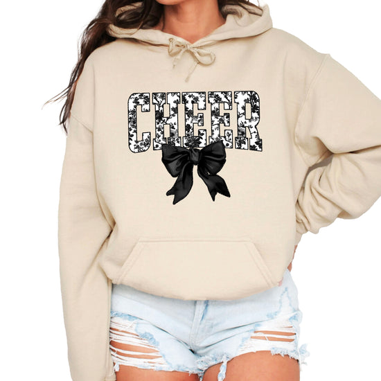 Sand cheer hoodie for women and teen girls, ink-printed black and white floral CHEER letters with coquette bow, photo 1 of 4