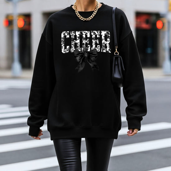 Black cheer sweatshirt with black floral bow design, styled view
