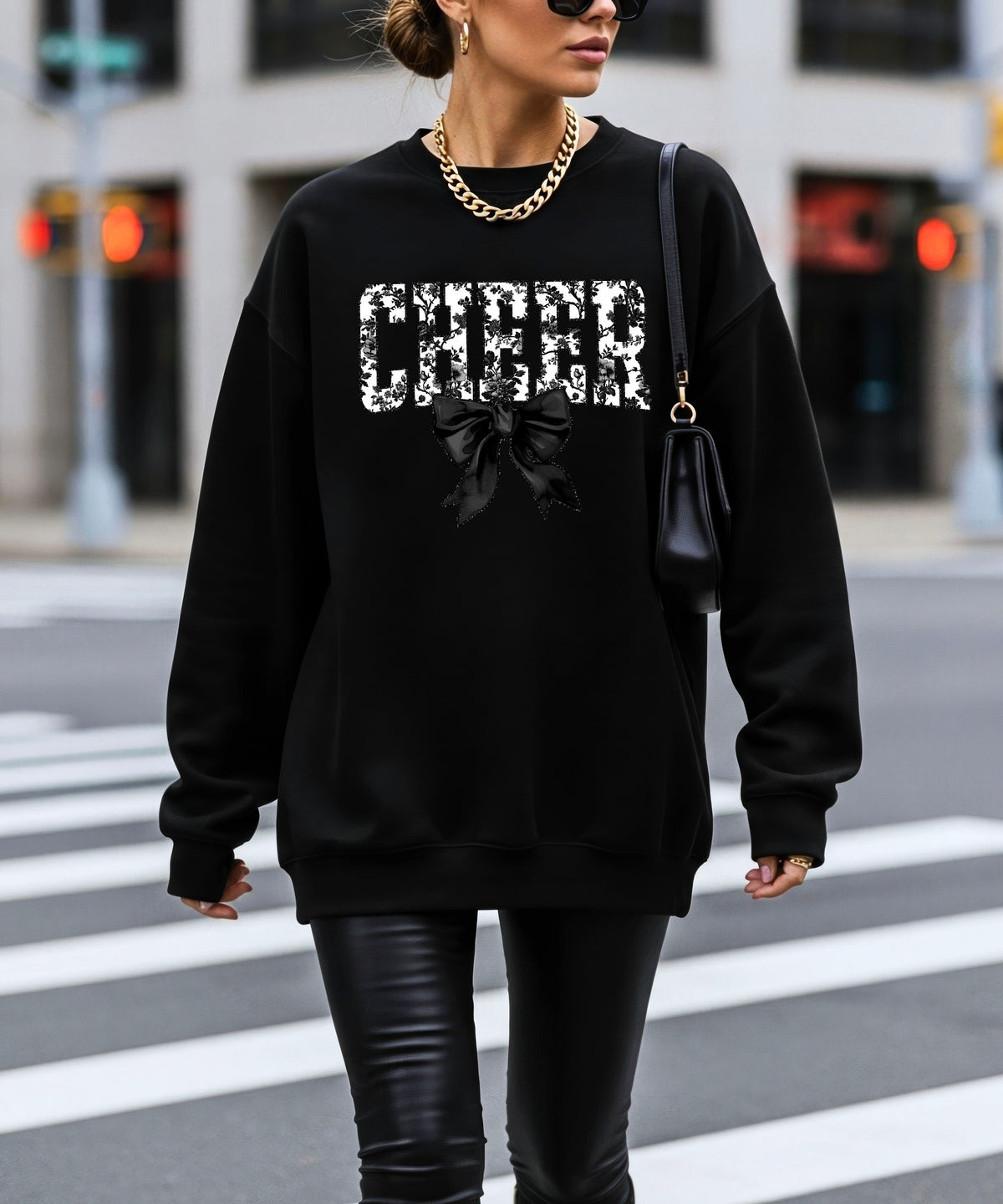 Black cheer sweatshirt with black floral bow design, styled view