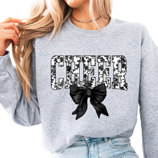 Gray cheer sweatshirt with black floral bow design, styled view