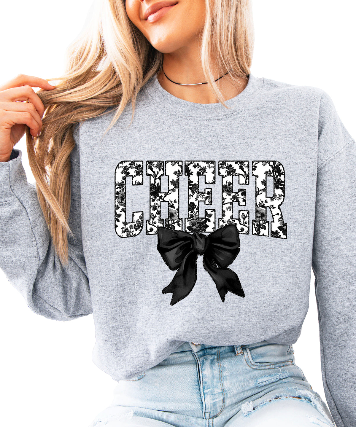 Gray cheer sweatshirt with black floral bow design, styled view