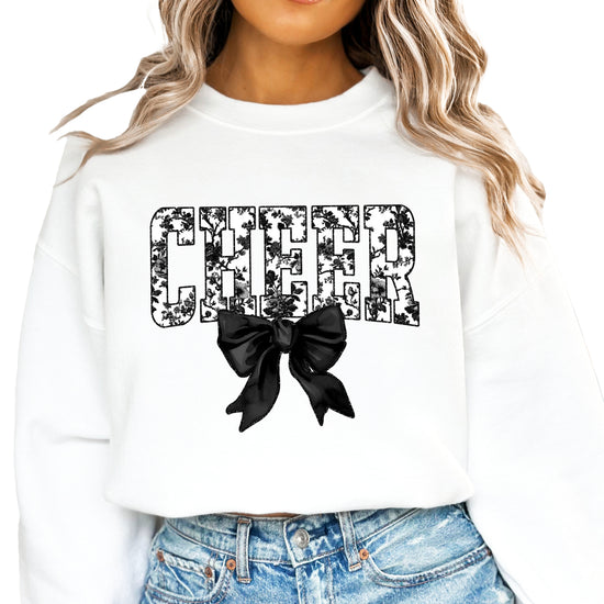 White cheer sweatshirt with black floral bow design, detail view