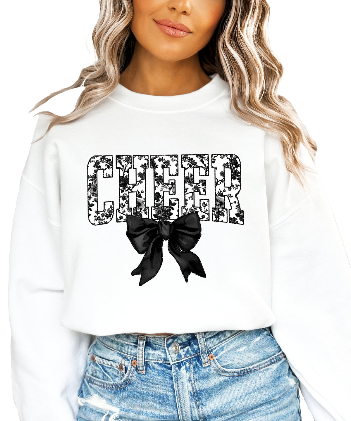 White cheer sweatshirt with black floral bow design, detail view