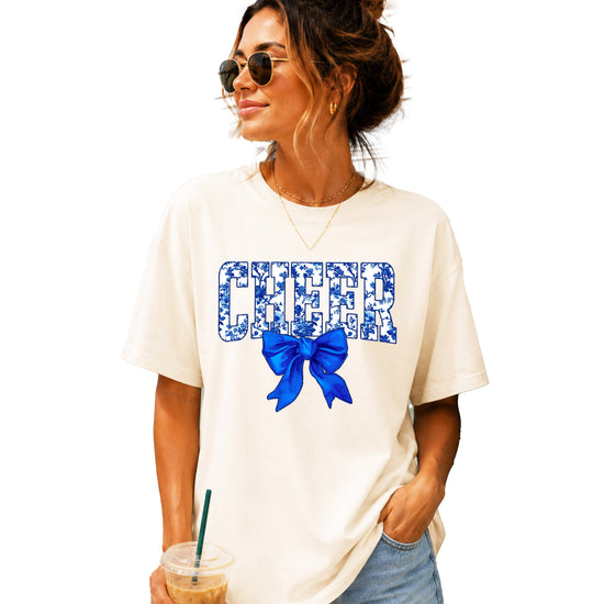Cheer blue floral coquette bow Comfort Colors tee for women in Ivory, front view