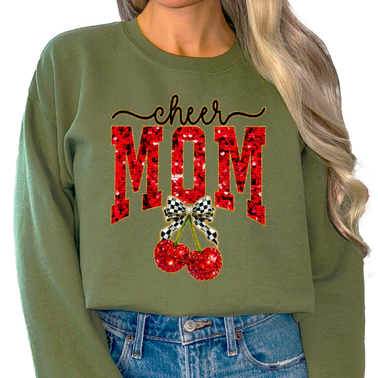 Army Green Cheerleader Mom crewneck sweatshirt with ink-printed faux sequin cheer script, MOM lettering and cherry coquette bow, close-up of the ink-printed design