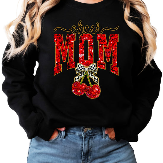 Black Cheerleader Mom crewneck sweatshirt with ink-printed faux sequin cheer script, MOM lettering and cherry coquette bow, close-up of the ink-printed design
