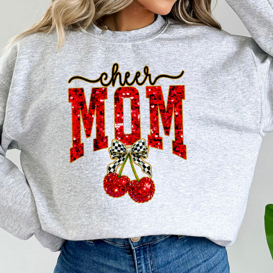 Gray Cheerleader Mom crewneck sweatshirt with ink-printed faux sequin cheer script, MOM lettering and cherry coquette bow, close-up of the ink-printed design