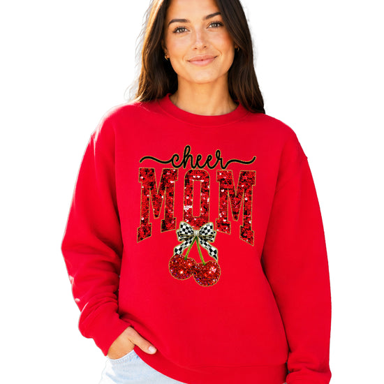 Red Cheerleader Mom crewneck sweatshirt with ink-printed faux sequin cheer script, MOM lettering and cherry coquette bow, close-up of the ink-printed design