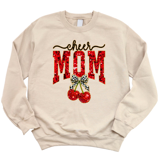 Sand Cheerleader Mom crewneck sweatshirt with ink-printed faux sequin cheer script, MOM lettering and cherry coquette bow, flat lay view