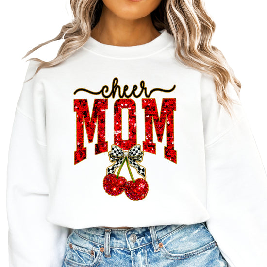 White Cheerleader Mom crewneck sweatshirt with ink-printed faux sequin cheer script, MOM lettering and cherry coquette bow, close-up of the ink-printed design