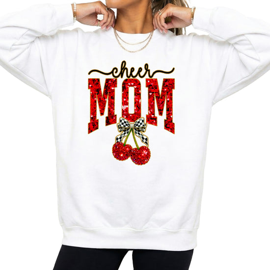 White Cheerleader Mom crewneck sweatshirt with ink-printed faux sequin cheer script, MOM lettering and cherry coquette bow, styled detail view