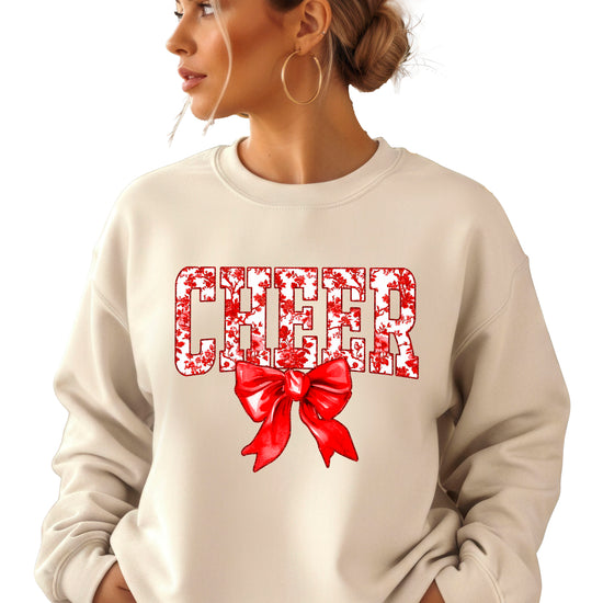 Sand crewneck sweatshirt with red floral CHEER lettering and red coquette bow, view 1