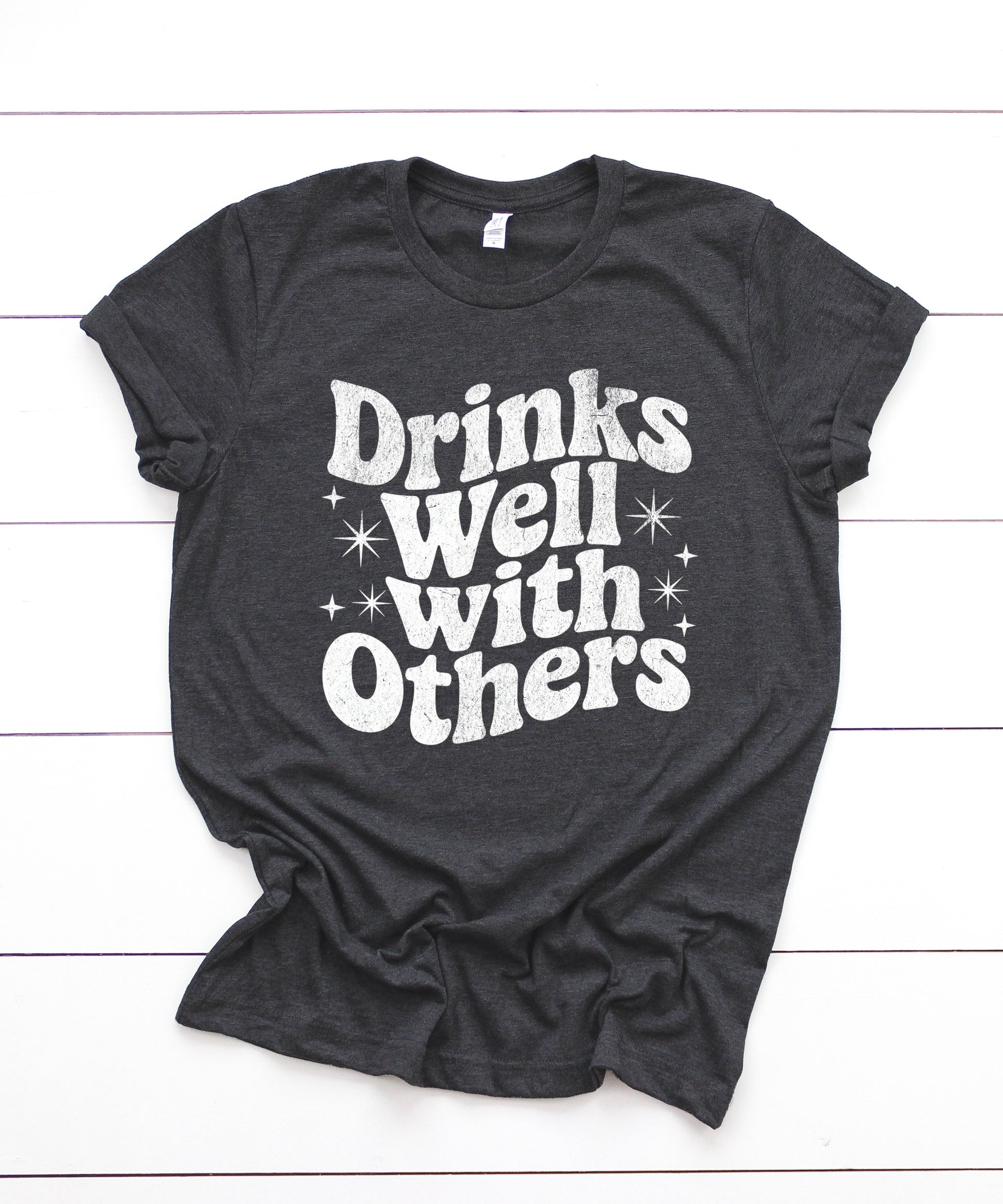 Drinks Well With Others funny graphic tee for women in Dark Gray Heather, lifestyle view