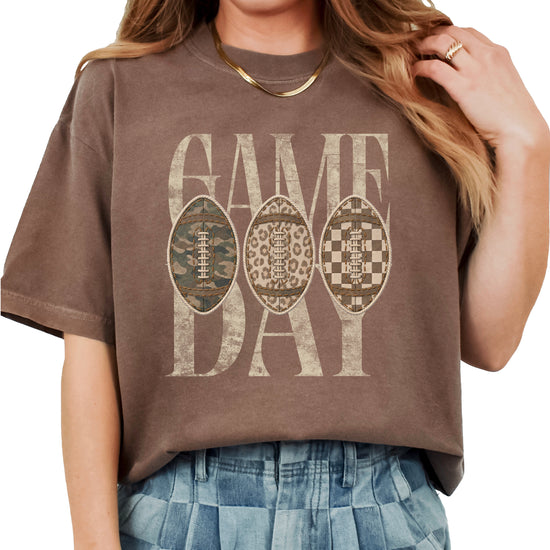 Game Day football shirt for women in Espresso, lifestyle view worn by a model, Comfort Colors 1717 garment-dyed heavyweight cotton tee by Olive Loves Apple