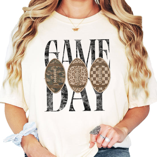 Game Day football shirt for women in Ivory, lifestyle view worn by a model, Comfort Colors 1717 garment-dyed heavyweight cotton tee by Olive Loves Apple