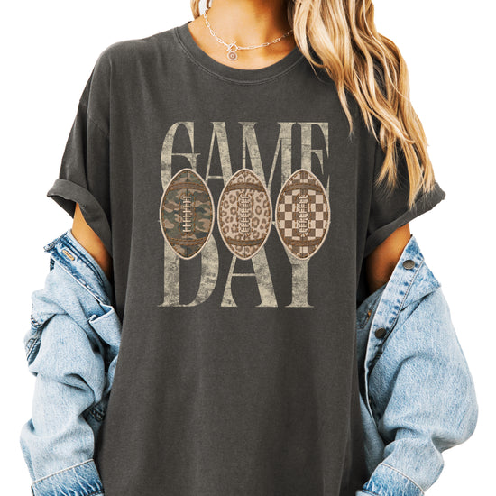 Game Day football shirt for women in Pepper, lifestyle view worn by a model, Comfort Colors 1717 garment-dyed heavyweight cotton tee by Olive Loves Apple