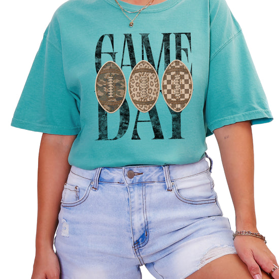 Game Day football shirt for women in Seafoam, lifestyle view worn by a model, Comfort Colors 1717 garment-dyed heavyweight cotton tee by Olive Loves Apple
