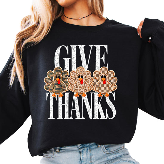 Give Thanks Thanksgiving sweatshirt for women in Black with camo, leopard and checkered turkeys